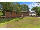Exterior shot of brick home with a spacious lawn and a covered carport at 1051 Old Us 421, Lillington, NC 27546