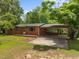 Brick ranch-style home with a covered carport and a spacious front yard, perfect for families at 1051 Old Us 421, Lillington, NC 27546