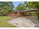 Brick ranch-style home with a covered carport and a spacious front yard, offering classic charm and functionality at 1051 Old Us 421, Lillington, NC 27546
