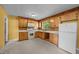 Classic kitchen with wooden cabinets, providing ample storage and functionality for everyday cooking needs at 1051 Old Us 421, Lillington, NC 27546