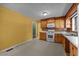 Kitchen with wooden cabinets, white appliances, and plenty of counter space at 1051 Old Us 421, Lillington, NC 27546