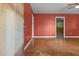 Living room with painted red walls, wooden floors, and view to the next room at 1051 Old Us 421, Lillington, NC 27546