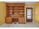 Office nook includes built-in shelving, a desk, and a door to the outside at 1051 Old Us 421, Lillington, NC 27546