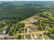 Aerial view showing an estimate of the property lines of the land, and warehouses on a wooded lot at 1085 Old Us 421, Lillington, NC 27546
