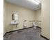Commercial bathroom featuring a urinal, standard toilet with grab bars, and a sink with mirror at 1085 Old Us 421, Lillington, NC 27546