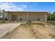 Industrial building with a loading dock, surrounded by a mix of dirt and sparse vegetation at 1085 Old Us 421, Lillington, NC 27546