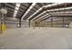 Spacious, empty warehouse featuring metal beams, high ceilings, and concrete floors at 1085 Old Us 421, Lillington, NC 27546