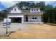 New construction home featuring a modern design, an attached garage, and a partially landscaped yard at 109 Arundel Dr, Archer Lodge, NC 27527
