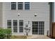 Back exterior with white vinyl siding, multiple windows, and sliding glass door at 1116 Kingston Grove Drive Dr, Cary, NC 27519