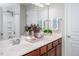 Bathroom with double sinks, framed mirror, and modern fixtures at 1116 Kingston Grove Drive Dr, Cary, NC 27519