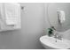 Modern bathroom with a pedestal sink, decorative mirror, and fresh white towels at 1116 Kingston Grove Drive Dr, Cary, NC 27519