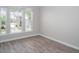 Comfortable bedroom with hardwood floors and multiple windows offering neighborhood views at 1116 Kingston Grove Drive Dr, Cary, NC 27519