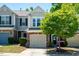 Charming townhome featuring a stone facade, attached garage, and manicured landscaping at 1116 Kingston Grove Drive Dr, Cary, NC 27519