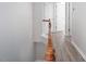 Upstairs hallway featuring hardwood floors, neutral paint, and white trim at 1116 Kingston Grove Drive Dr, Cary, NC 27519