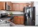 Well-equipped kitchen featuring stainless steel appliances, wood cabinets, and gas range at 1116 Kingston Grove Drive Dr, Cary, NC 27519