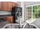 Functional kitchen with stainless steel appliances, new floors, and a door leading to the patio at 1116 Kingston Grove Drive Dr, Cary, NC 27519