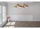 Open living room with new floors, fresh paint, and modern lighting at 1116 Kingston Grove Drive Dr, Cary, NC 27519