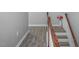 Well-lit staircase with hardwood railing and white trim, showcasing a smooth transition between floors at 1116 Kingston Grove Drive Dr, Cary, NC 27519