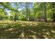 Large backyard featuring mature trees and a fence perimeter at 112 Rectory St, Oxford, NC 27565