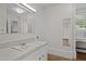 Bathroom features a white sink with chrome fixtures, mirror, and white cabinets at 112 Rectory St, Oxford, NC 27565
