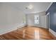 Bright, empty room with hardwood floors, white walls, and natural light from the windows at 112 Rectory St, Oxford, NC 27565
