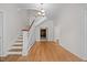 Entryway featuring hardwood floors, staircase with white railing, and views into adjacent rooms at 112 Rectory St, Oxford, NC 27565