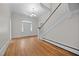 Spacious foyer boasting hardwood floors, staircase with white railing and trim, and decorative door at 112 Rectory St, Oxford, NC 27565