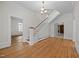 Bright foyer features hardwood floors, staircase with white railing and trim, and chandelier at 112 Rectory St, Oxford, NC 27565