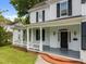 Charming front porch with white columns and black shutters enhances this home's curb appeal at 112 Rectory St, Oxford, NC 27565
