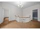 Hallway features hardwood floors, a curved staircase, and access to adjacent rooms at 112 Rectory St, Oxford, NC 27565