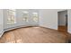 Bright living room with hardwood floors, a trio of windows, and crisp white trim at 112 Rectory St, Oxford, NC 27565