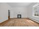Sunlit living room featuring hardwood floors, a fireplace, and views into adjacent rooms at 112 Rectory St, Oxford, NC 27565