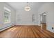 Living room with hardwood floors, arched alcoves, and natural light at 112 Rectory St, Oxford, NC 27565