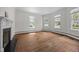 Bright living room boasting hardwood floors, a decorative fireplace, and multiple windows at 112 Rectory St, Oxford, NC 27565