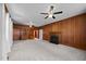 Large living room with wood paneling, a fireplace, built-in bookshelves, and plush carpeting at 112 Rectory St, Oxford, NC 27565