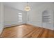 Living room with hardwood floors, arched alcoves, and natural light at 112 Rectory St, Oxford, NC 27565