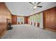 A spacious living room features wood paneling, carpet, a fireplace, and three large windows at 112 Rectory St, Oxford, NC 27565
