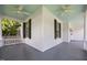 Wrap around porch featuring vintage fans, white columns, and blue ceilings at 112 Rectory St, Oxford, NC 27565