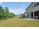 Spacious backyard featuring a covered patio, ample grass, and trees around the border at 121 Canyon Gap Way, Raleigh, NC 27610