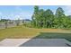 A spacious backyard featuring a lawn, garden, and lush greenery for outdoor enjoyment at 121 Canyon Gap Way, Raleigh, NC 27610