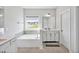 Well-lit bathroom features a soaking tub with a view and a spacious vanity at 121 Canyon Gap Way, Raleigh, NC 27610