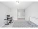 Minimalist bedroom with a cozy bed, computer and neutral carpet flooring at 121 Canyon Gap Way, Raleigh, NC 27610