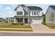 Charming two-story home featuring stone accents, a two-car garage, manicured lawn, and beautifully landscaped front yard at 121 Canyon Gap Way, Raleigh, NC 27610