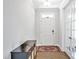 Entryway featuring hardwood floors, a stylish console table, and a bright white front door and sidelight panels at 121 Canyon Gap Way, Raleigh, NC 27610