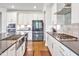 A modern kitchen showcases stainless steel appliances, and white cabinetry at 121 Canyon Gap Way, Raleigh, NC 27610