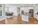 Bright, open-concept kitchen and dining area, featuring stainless steel appliances and island at 121 Canyon Gap Way, Raleigh, NC 27610