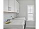 Bright laundry room features white cabinets and modern washer and dryer at 121 Canyon Gap Way, Raleigh, NC 27610