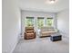 Spacious living room featuring a tan sofa, leather recliner and three large windows at 121 Canyon Gap Way, Raleigh, NC 27610