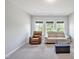 Living room offers neutral walls, carpet and a beige sofa, and a recliner with natural light from windows at 121 Canyon Gap Way, Raleigh, NC 27610