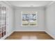 Bright home office featuring hardwood floors, French doors, and a large window with neighborhood views at 121 Canyon Gap Way, Raleigh, NC 27610